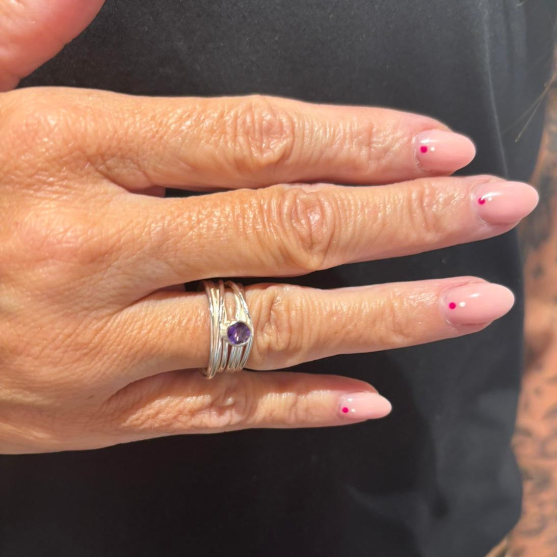 Faceted amethyst stone set on a silver 7 wrap Ring
