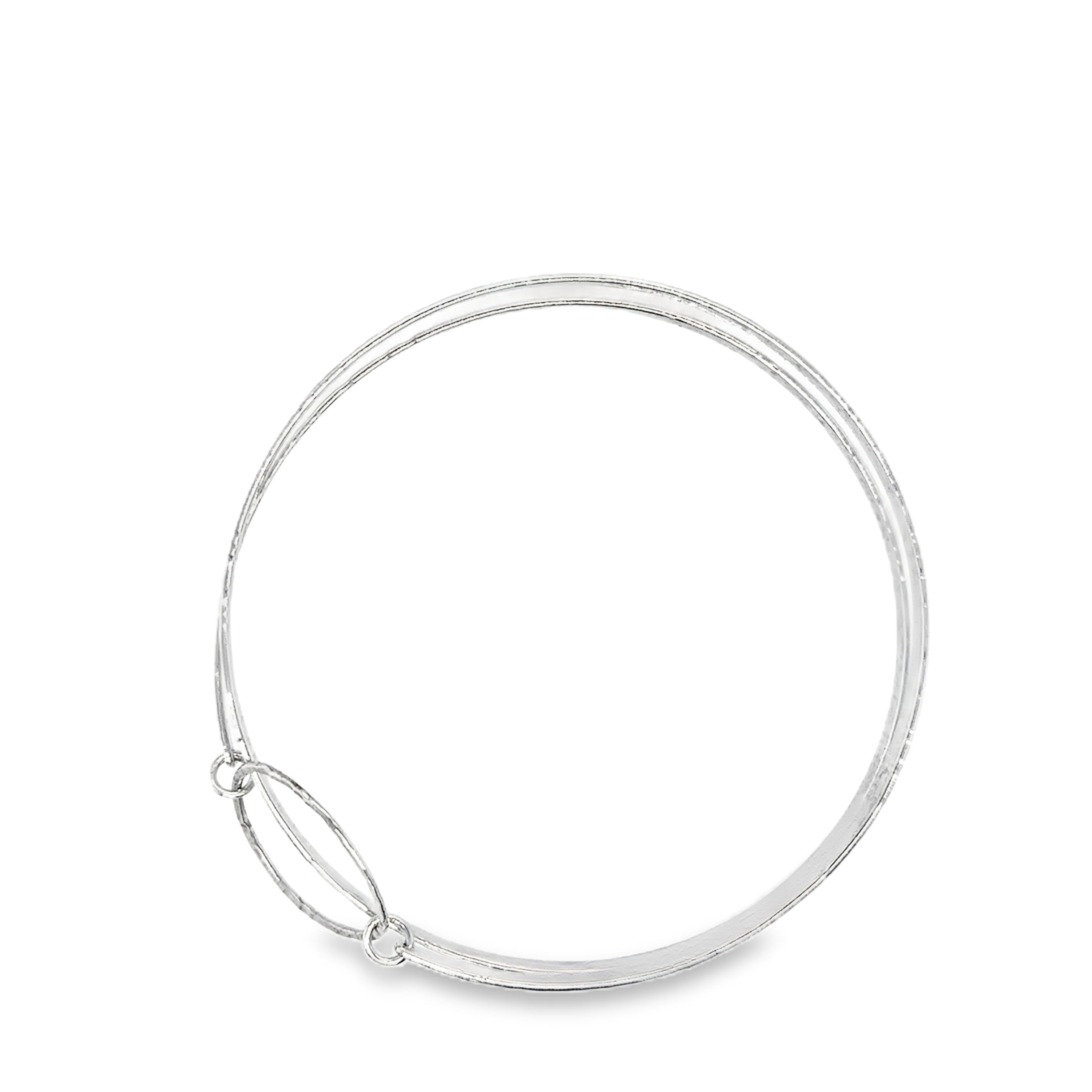Hammered two spiral textured silver bangle with silver heart