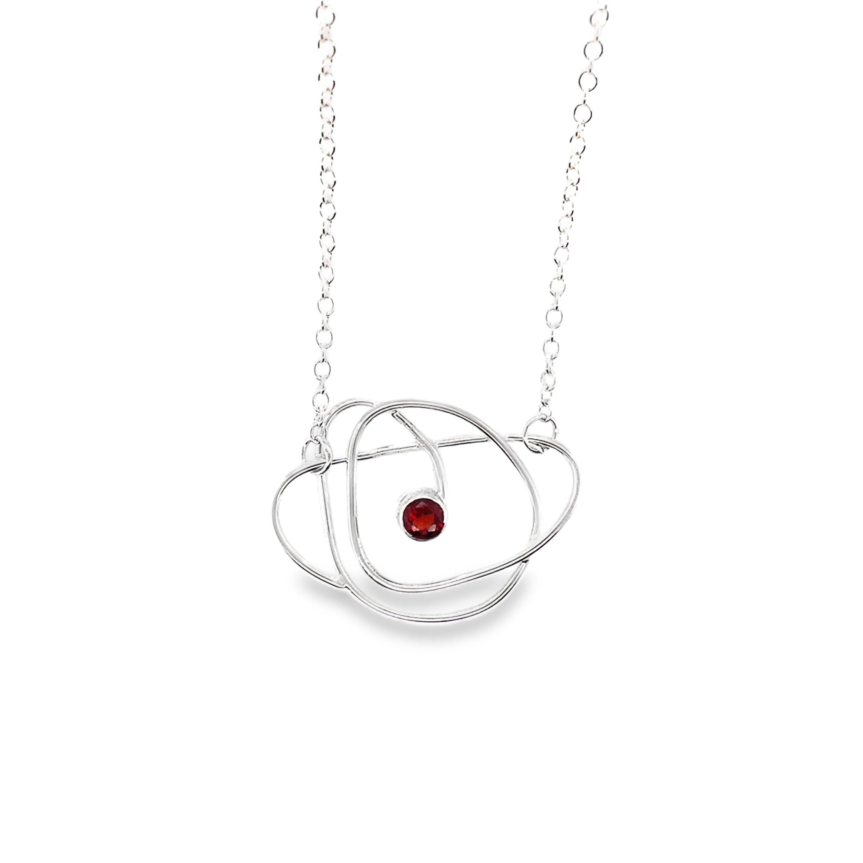 Faceted red garnet stone set on a silver wrap necklace