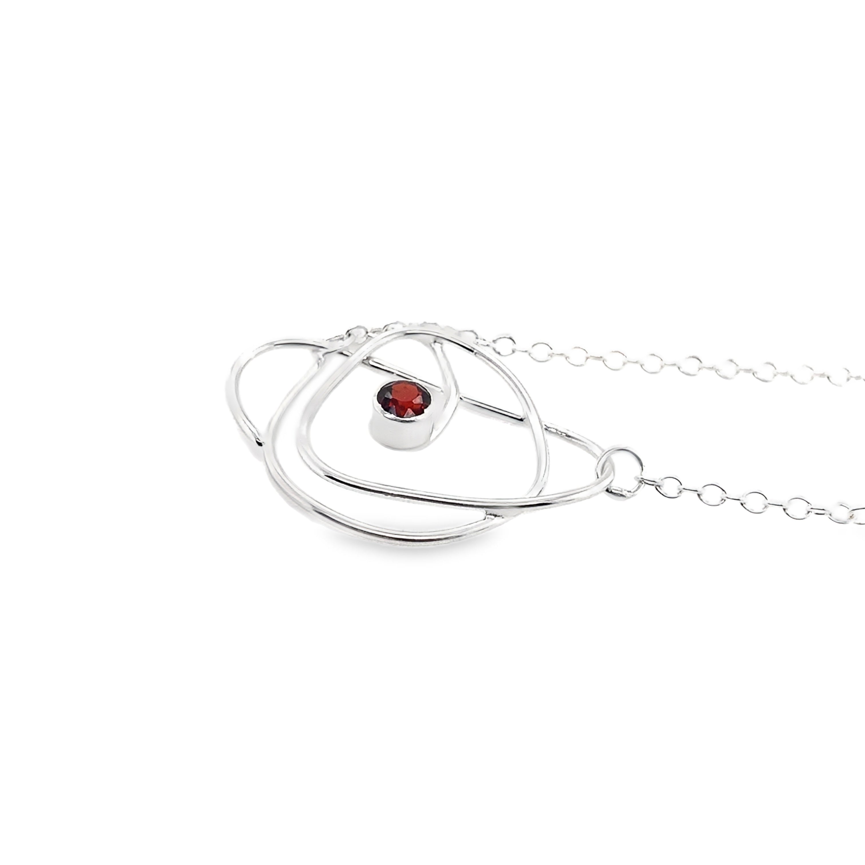 Faceted red garnet stone set on a silver wrap necklace