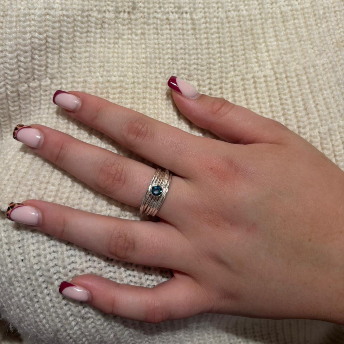 Faceted London blue topaz stone set on a silver 7 wrap ring