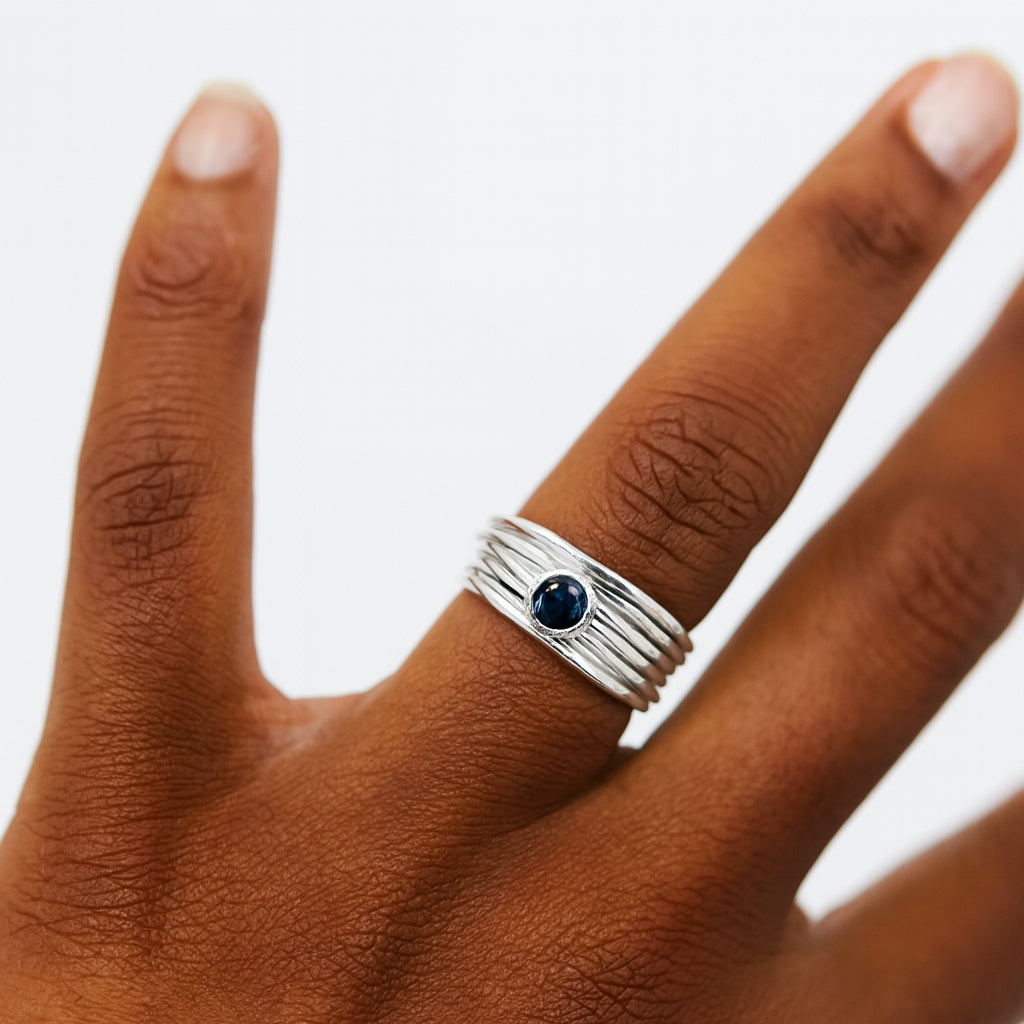 Faceted London blue topaz stone set on a silver 7 wrap ring