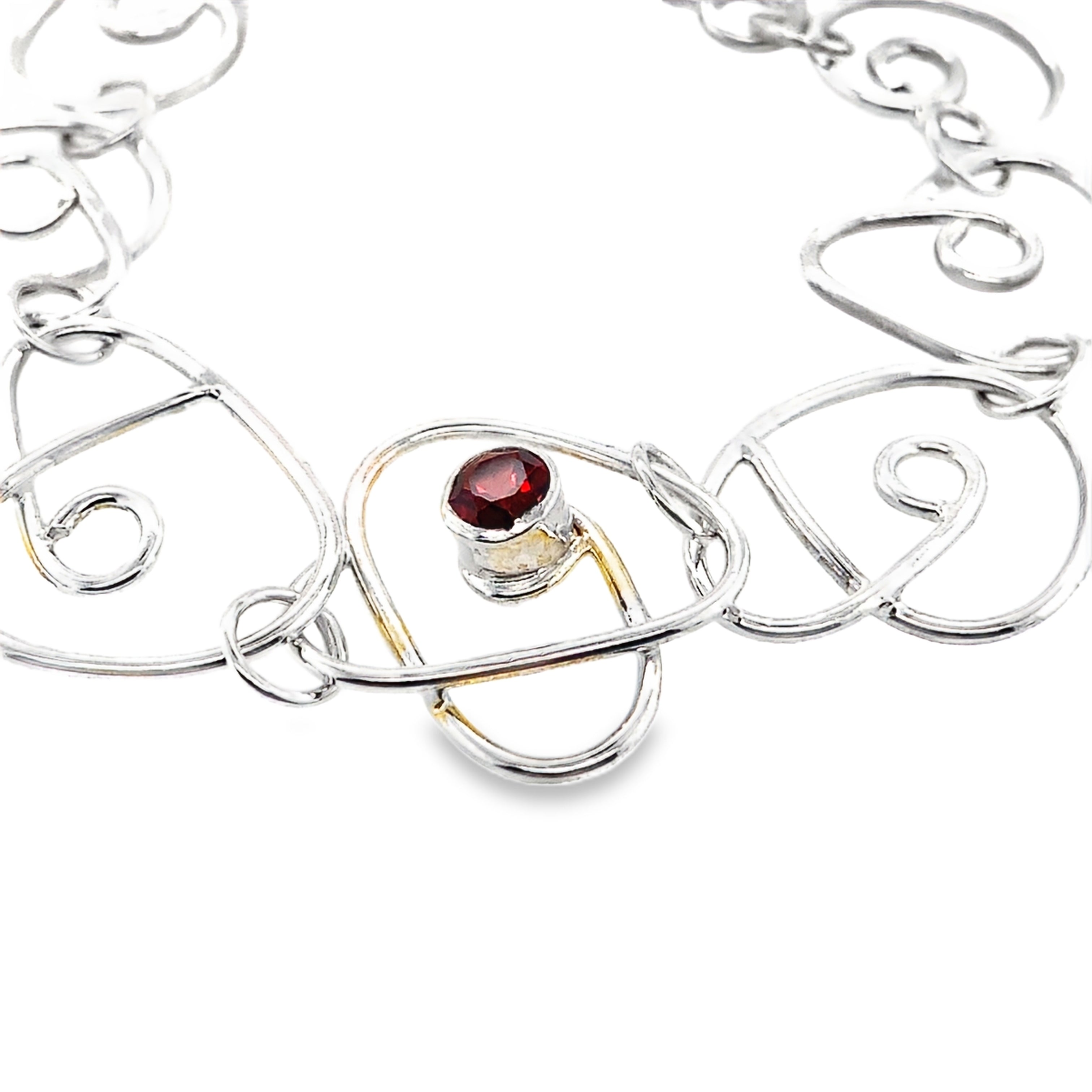Faceted red garnet stone set on a full wrap silver bracelet