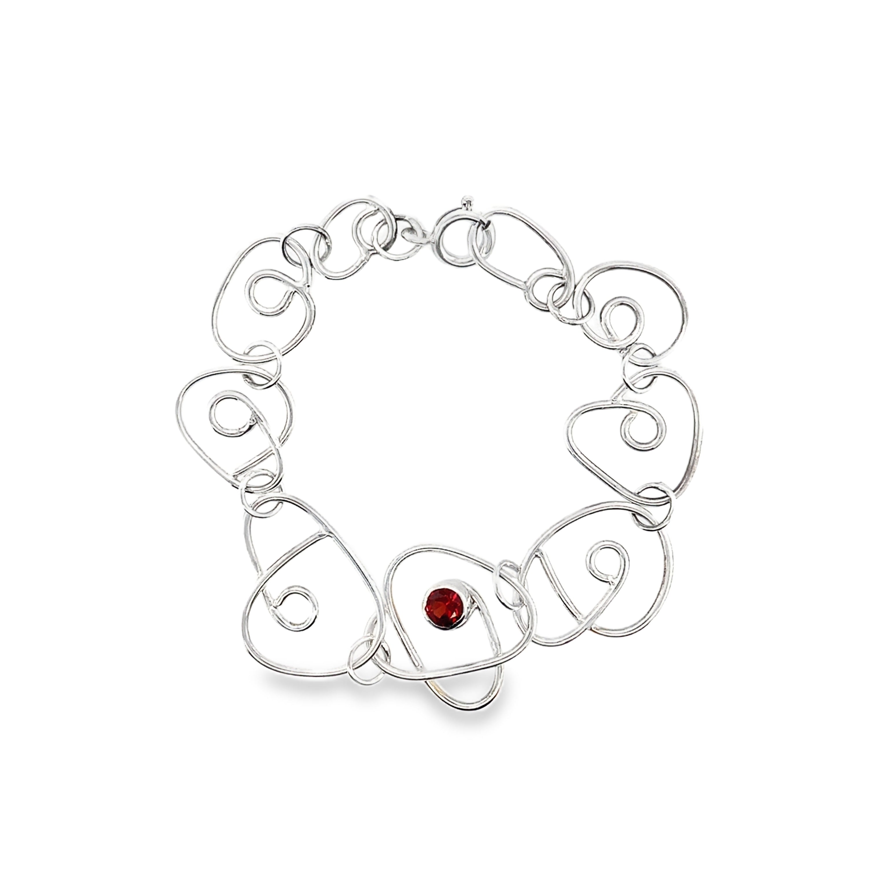 Faceted red garnet stone set on a full wrap silver bracelet