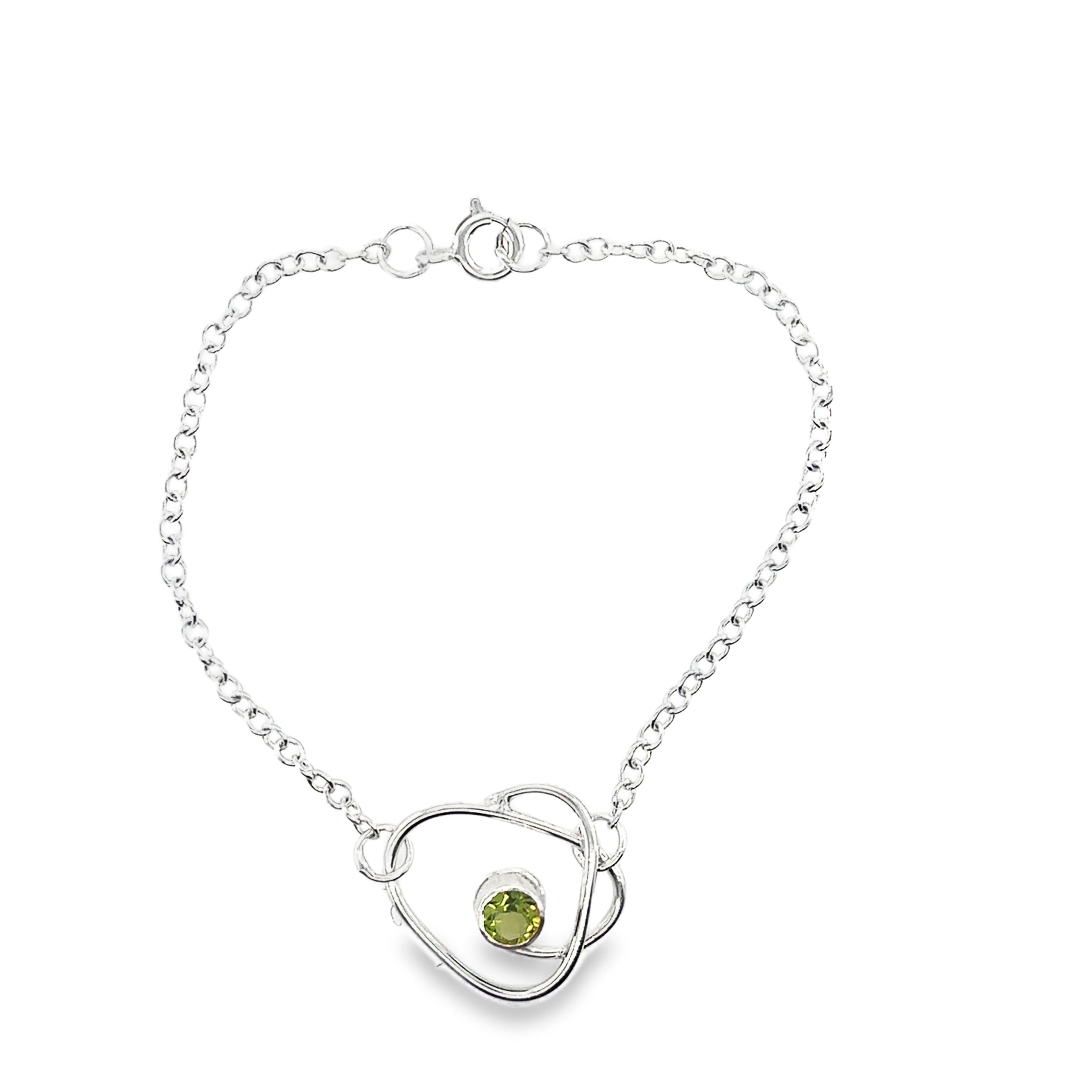 Faceted peridot set on a silver wrap bracelet