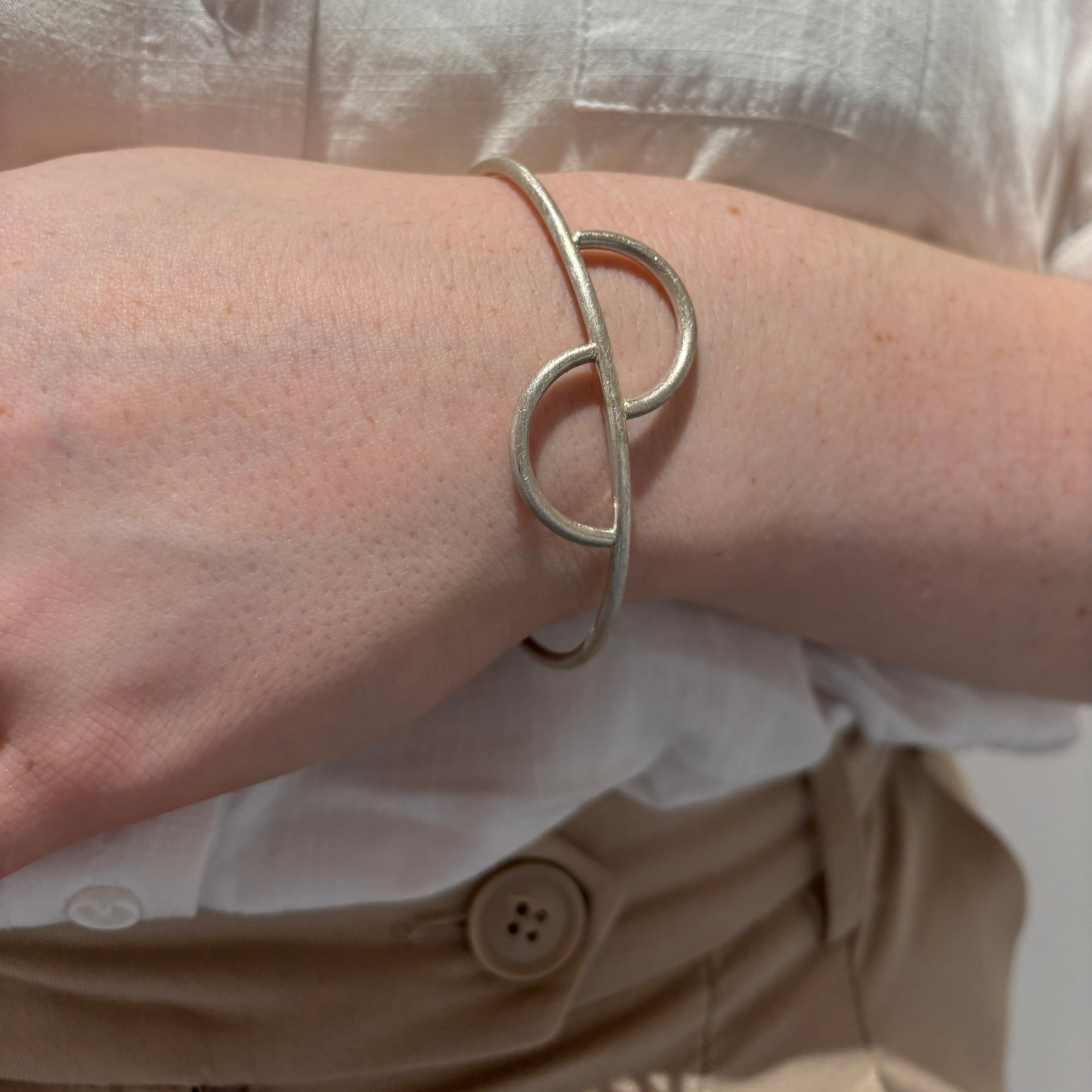 Silver Split oval bangle with a scratch matt finish